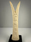 Egyptian revival candlestick holders in carved bone with symbolic floral and plant motifs