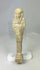 Ancient limestone ushabti on a clear acrylic stand with visible mineral deposits