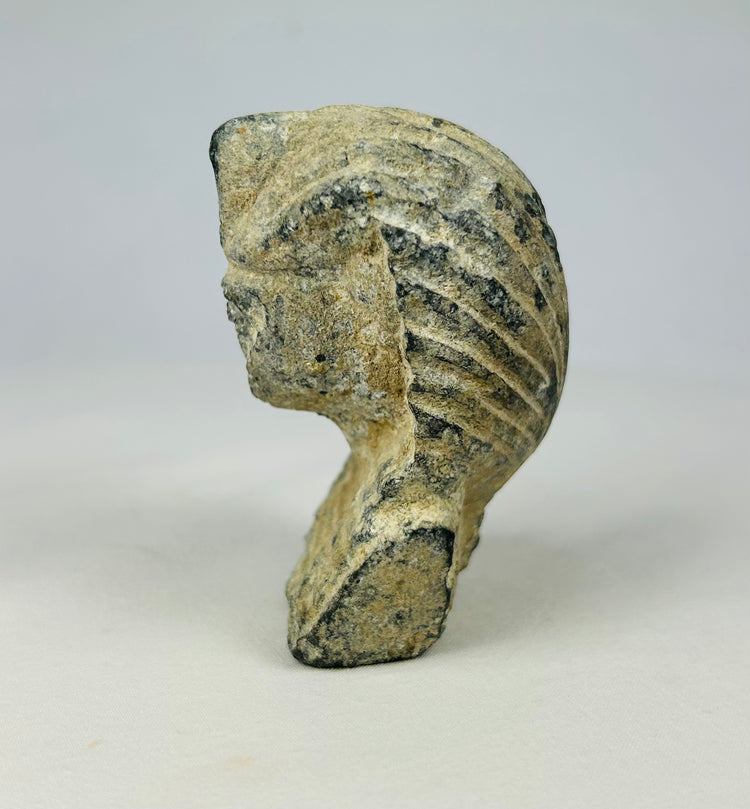 Limestone carving of a pharaoh’s head with nemes headdress and uraeus symbol, early Grand Tour period collectible (c. 1800–1920), displayed on a neutral background.