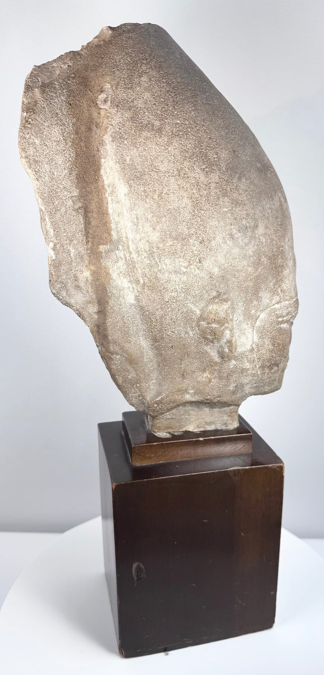 Tiered dark hardwood stand supporting the Egyptian Revival pharaoh head sculpture