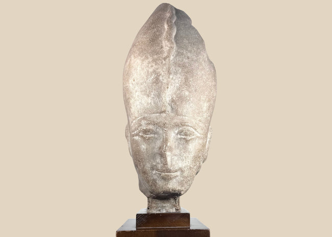 Egyptian Revival pharaoh head sculpture wearing the White Crown on a dark hardwood display stand