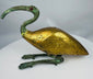 Mid-20th century Egyptian Revival ibis sculpture featuring a gold-colored body and green patinated metal elements.