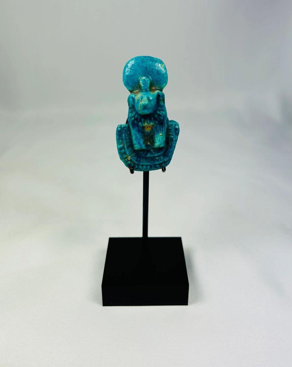 Ancient Egyptian faience amulet depicting Sekhmet, lion-headed goddess of war and protection, turquoise-blue in color with tripartite wig, dual suspension holes, Third Intermediate to Late Period, circa 1070–664 BCE.