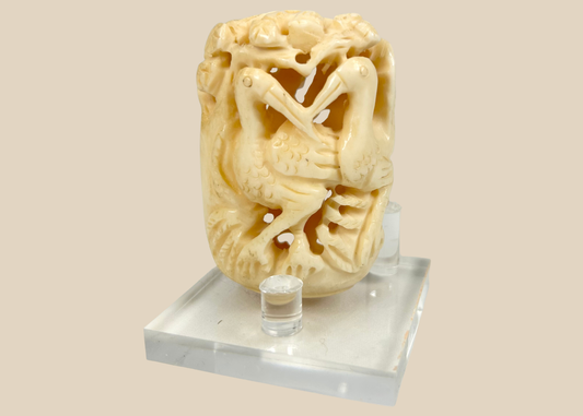 Japanese finely carved bone ornament featuring intertwined birds and foliage, Meiji to early 20th century