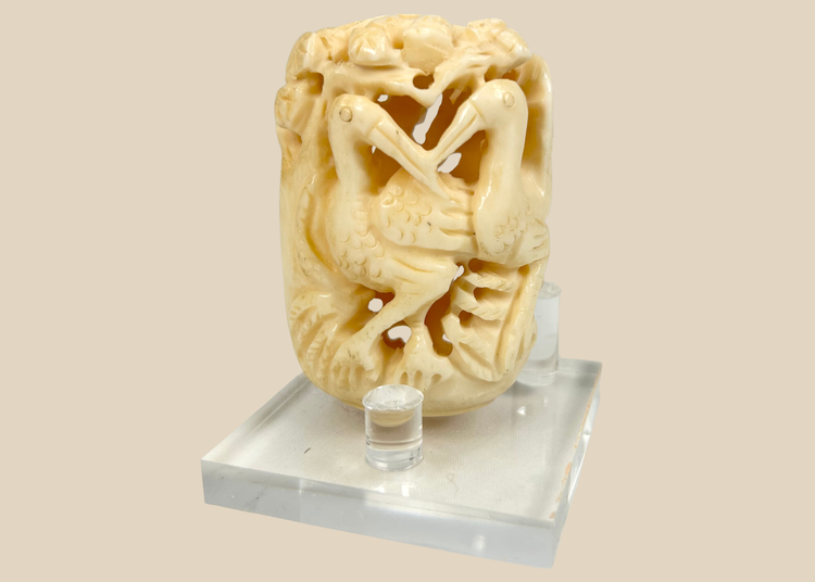 Japanese finely carved bone ornament featuring intertwined birds and foliage, Meiji to early 20th century