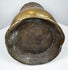 Underside of an 18th-century English brass tankard showing the circular foot and aged base with historic surface wear.