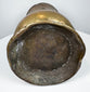 Underside of an 18th-century English brass tankard showing the circular foot and aged base with historic surface wear.