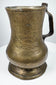 18th-century brass ale tankard displaying its curved handle, rounded body, and characteristic Georgian period construction.