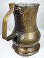 Antique George II brass tankard circa 1727–1760 showing its hand-crafted form, aged brass surface, and historic character.