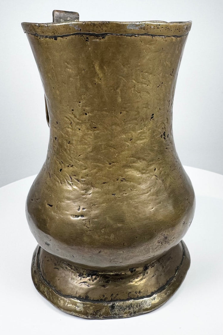 Antique English brass drinking vessel from the Georgian era with baluster body and centuries-old surface wear.
