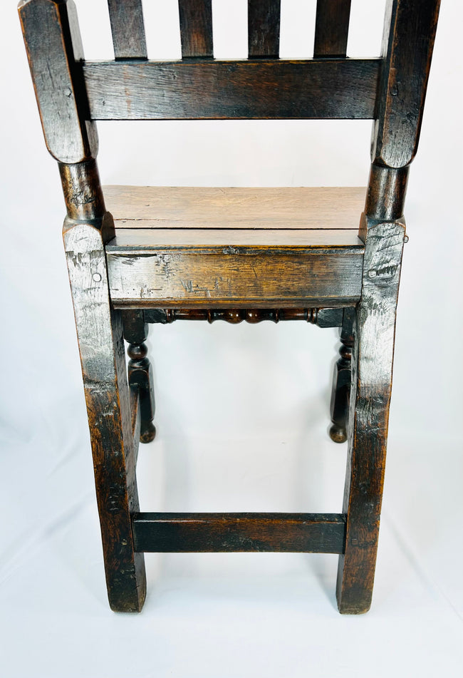 High back English oak chair with narrow vertical slats and aged patina