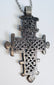 Handcrafted Ethiopian Coptic devotional cross pendant with pierced lattice pattern and suspension loop.
