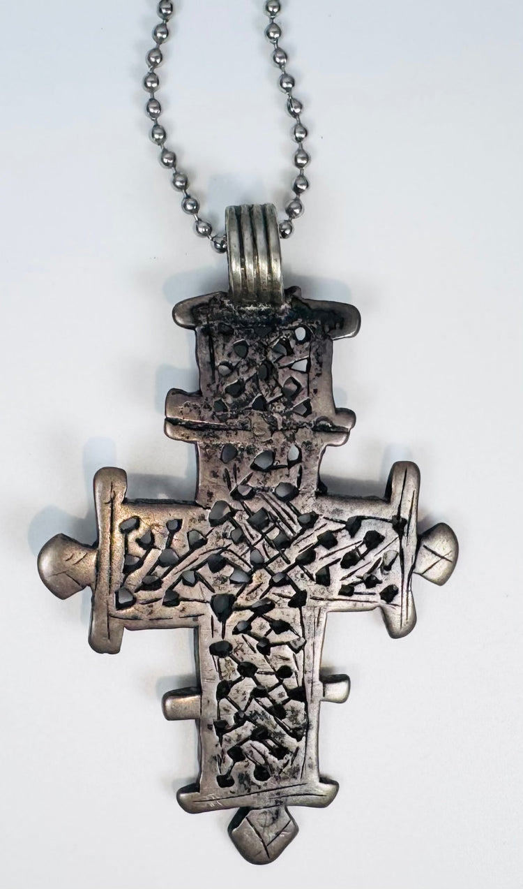 Ethiopian Coptic cross pendant showcasing intricate geometric symbolism and historic Christian craftsmanship.