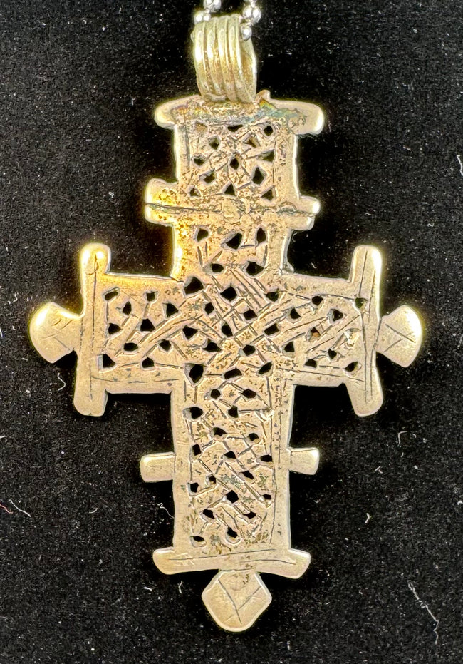 Large Ethiopian Coptic cross pendant with detailed latticework, handcrafted in the traditional Orthodox style.