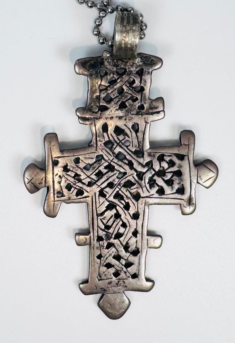 Traditional Ethiopian Orthodox Christian cross pendant featuring elaborate geometric openwork craftsmanship.