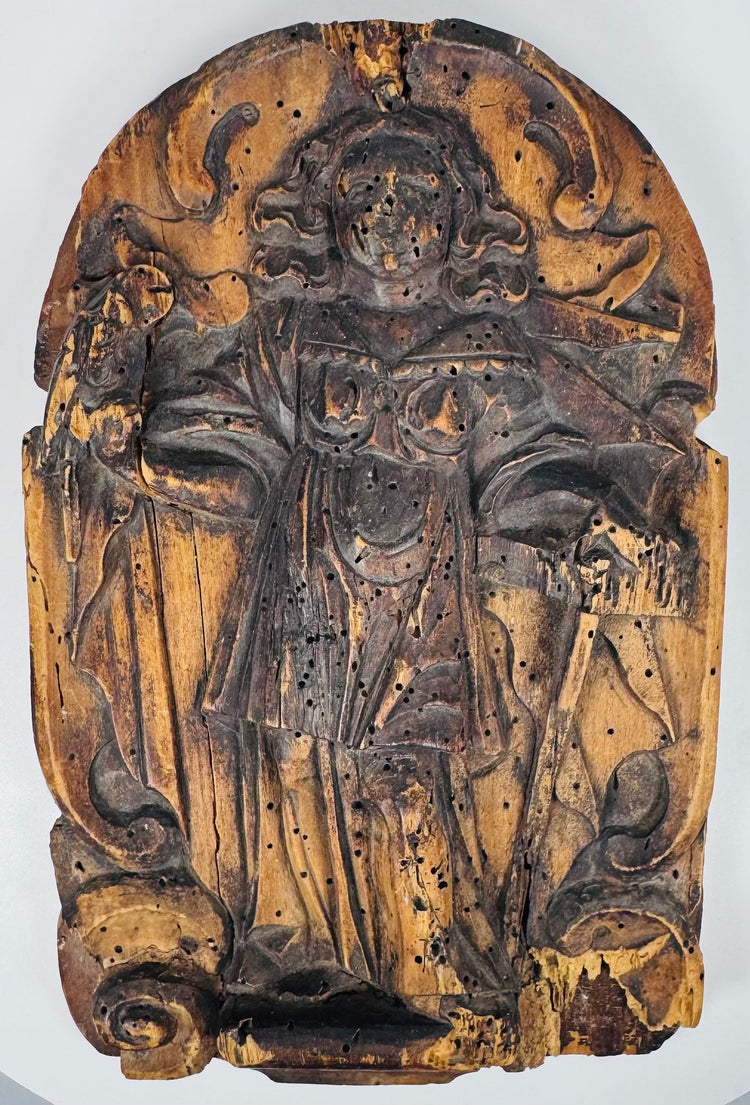 Side view of a 19th-century European wooden religious relief mounted on a later backing panel