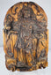 Close-up of an antique carved wooden saint with a circular halo and staff-like devotional attribute
