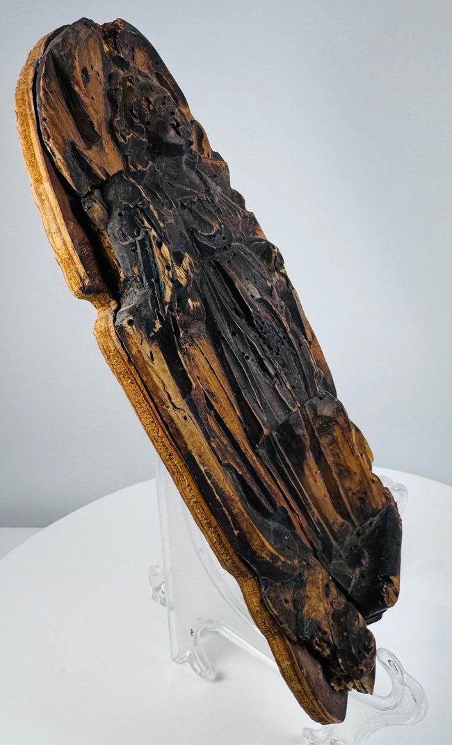 Heavily weathered Christian devotional relief with carved foliate ornamentation and historic wormholes