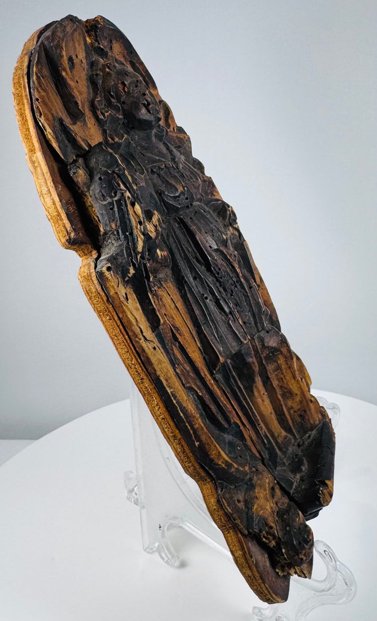 Heavily weathered Christian devotional relief with carved foliate ornamentation and historic wormholes