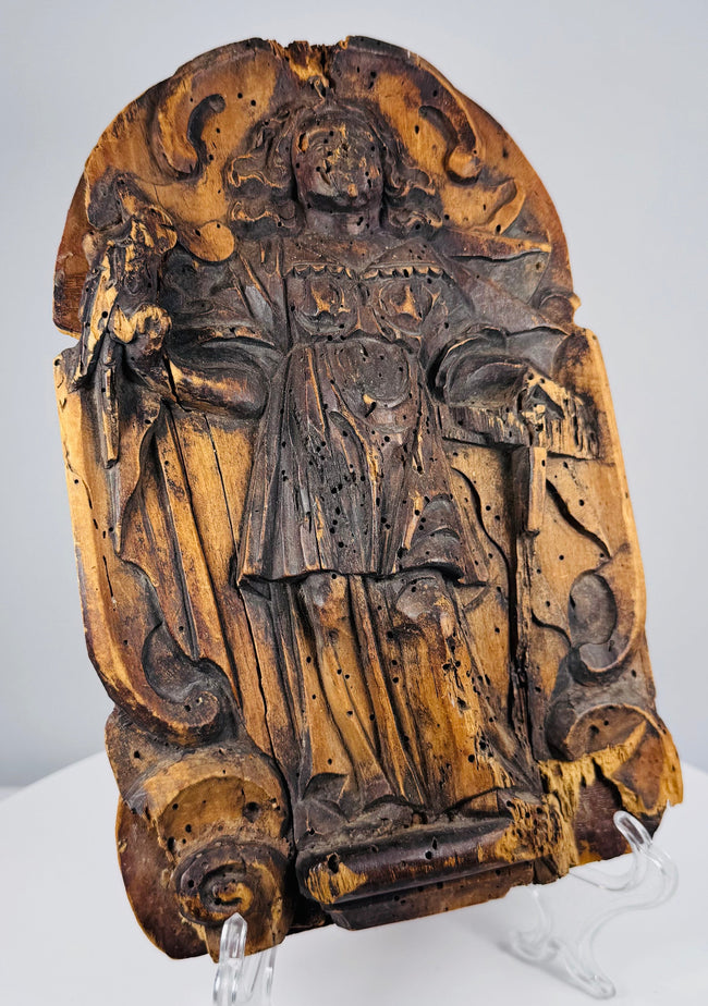 Antique European saint carving showing extensive age-related erosion, cracking, and surface losses