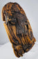 Lower section of a hand-carved devotional panel with worn robes and deeply carved cloudlike decoration