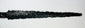 Close-up of 14th-century European dagger blade with heavy corrosion and pitted surface, displayed flat on a white background.