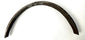 Curved steel band on white cloth showing arch shape, tapered ends, and inventory marking