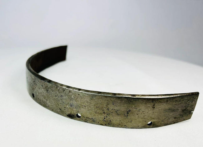 Close-up of forged steel texture on 17th-century armor band, showing hammer marks, patina, and wear from use.
