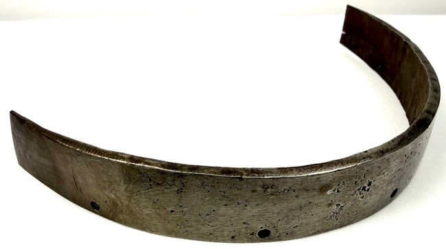 Antique forged steel armor band with a thick curved structure, subtle hammering marks, and centuries of surface aging.