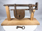 Antique warded iron key beside an 18th-century sliding hasp door lock