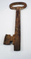 Large antique iron key from 18th-century Europe with classic oval bow and functional locksmithing design.