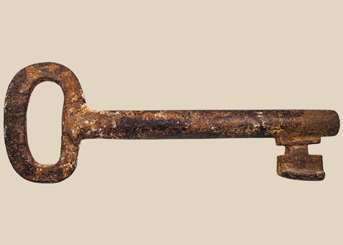 18th-century European forged iron skeleton key with oval bow, wedge-shaped ward, and developed patina, used for warded locks in manors, castles, or estates.
