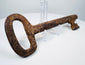 Antique European skeleton key from the 1700s featuring a wedge-shaped ward and hand-forged iron construction.
