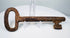18th-century European forged iron skeleton key with oval bow, thick shaft, and aged surface patina.