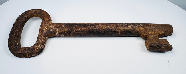 European forged iron skeleton key showing a substantial shaft, defined ward, and naturally developed antique patina.