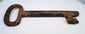 European forged iron skeleton key showing a substantial shaft, defined ward, and naturally developed antique patina.
