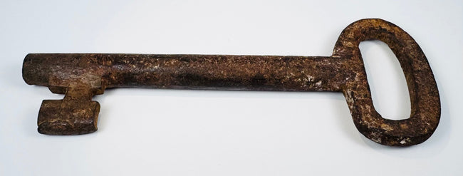 Early European warded-lock key in forged iron, circa 18th century, with age-related surface wear and preserved form.