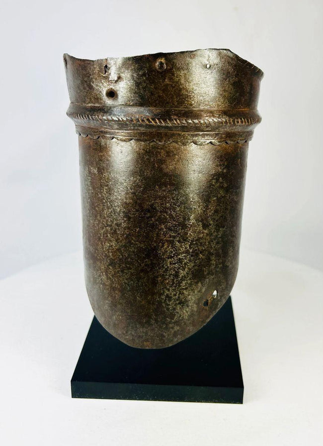 Renaissance steel upper arm protection piece showing scalloped rim, perforations for attachment, and aged patinated surface.