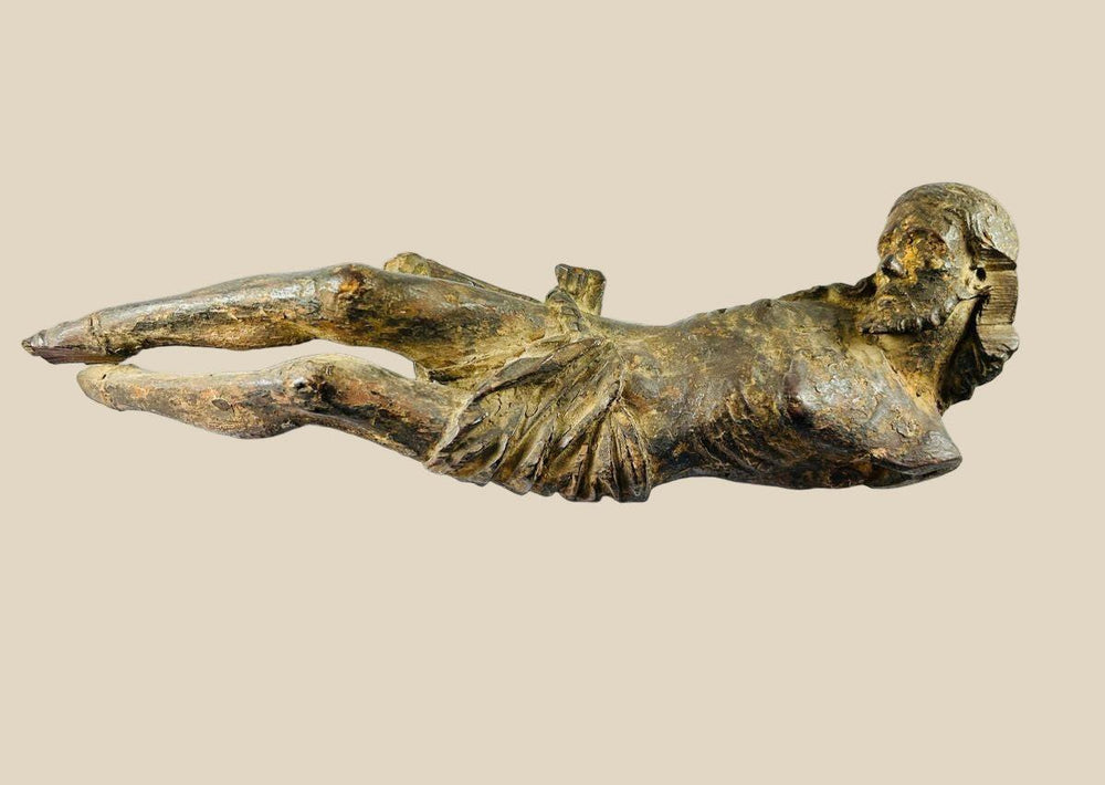 Hand-carved 17th-century Baroque wooden crucifix depicting Christ with expressive features and natural patina, suitable for devotional or display purposes.