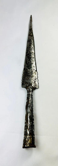 Forged iron spearhead from Europe, Iron Age to Early Medieval period (circa 1st millennium CE), featuring a scalloped-edge blade, socketed base, and historic mixed-metal brazed repair. Natural patina and surface texture reflect centuries of use, craftsmanship, and cultural significance as both a functional weapon and symbol of status.