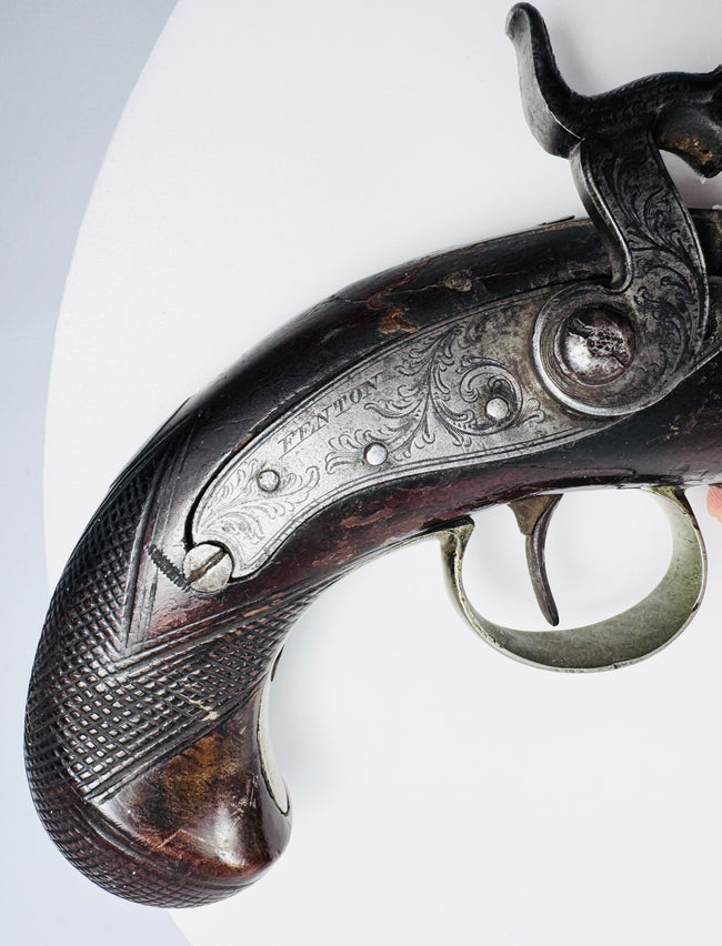 Detailed view of checkered walnut grip on Fenton of London 19th-century percussion pistol