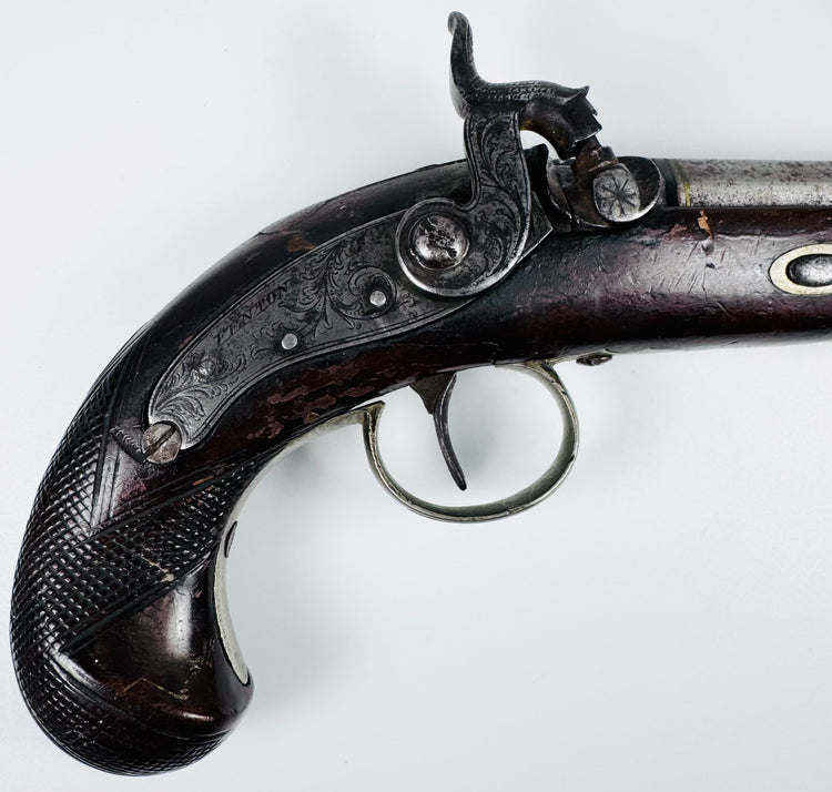 Close-up of engraved steel lockplate on antique Fenton London percussion pistol
