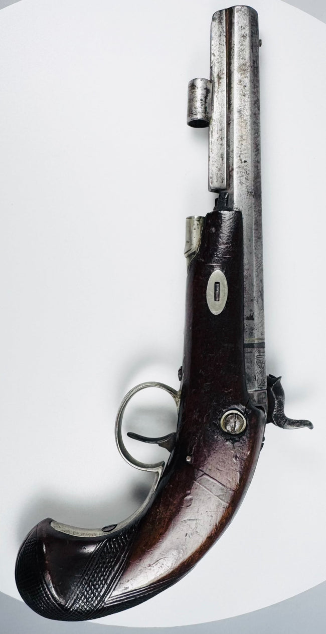 Top view of antique Fenton percussion pistol showing octagonal barrel and engraved steel fittings