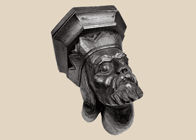 Antique European carved wooden king corbel with dark aged finish