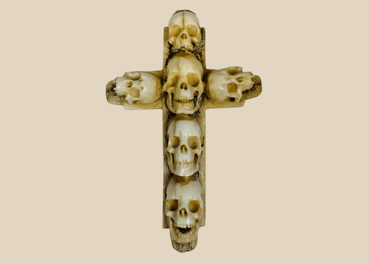 Antique hand-carved bone memento mori cross featuring six human skulls