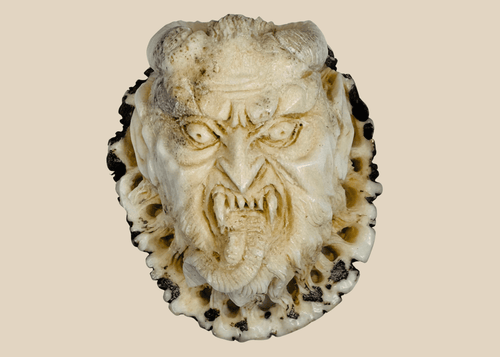 Antique Japanese stag antler oni demon face carving in deep relief