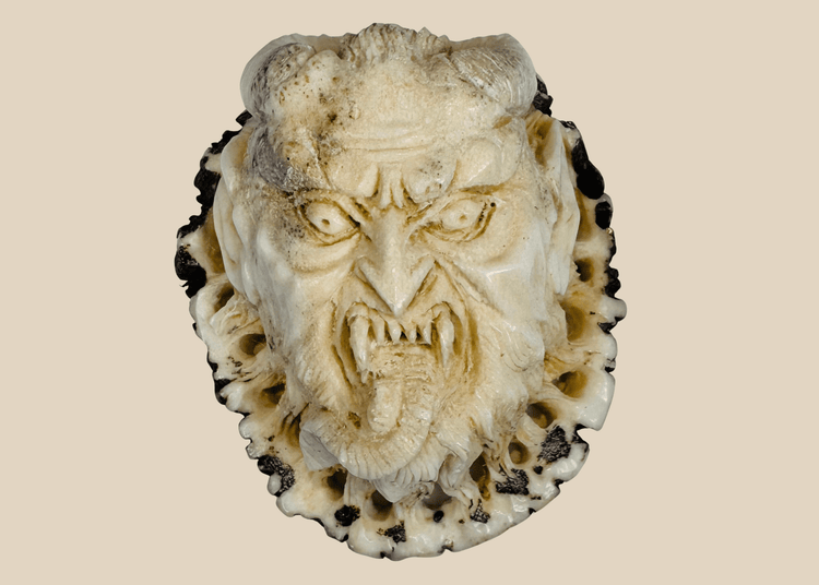 Antique Japanese stag antler oni demon face carving in deep relief