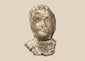 Ancient Greek terracotta protome with stylized human face, broad shoulders, and weathered pale surface