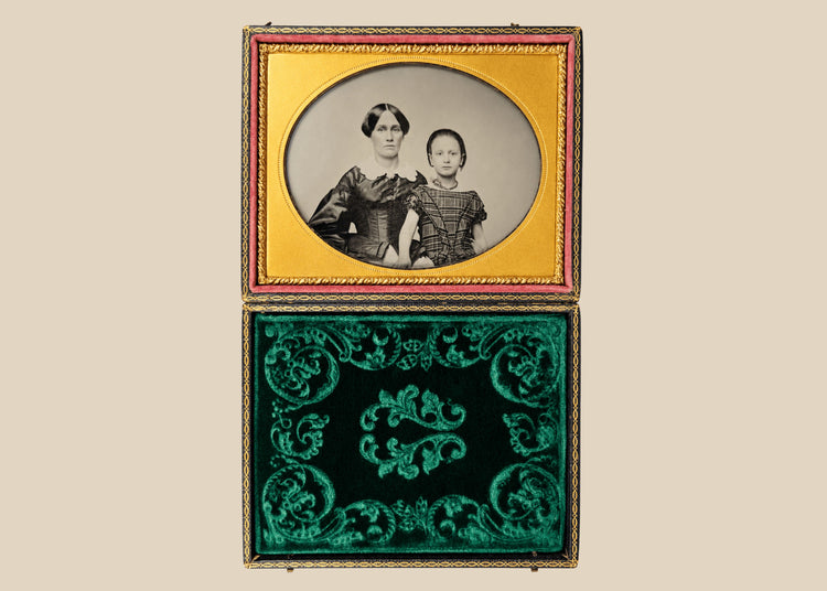 Mid-19th-century cased ambrotype portrait of an adult woman and young child with gilt-brass mat and green velvet lining