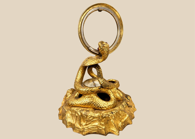 Victorian gilt bronze cobra inkstand designed by Benjamin Waterhouse Hawkins in 1850, featuring a coiled serpent and scientific instruments.